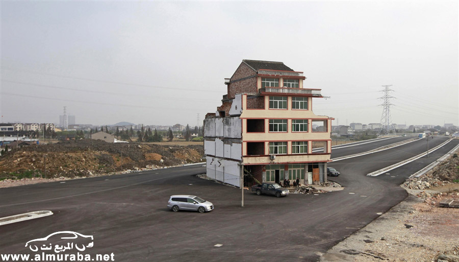 الحكومة الصينية تهدم المنزل الذي كان في وسط الطريق في تشجيانغ بعد تعويض صاحبها بمبلغ اكبر بالصور 11
