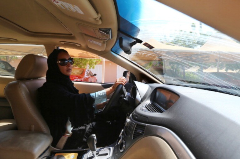 TO GO WITH AFP STORY BY ACIL TABBARA  Saudi activist Manal Al Sharif, who now lives in Dubai, drives her car in the Gulf Emirate city on October 22, 2013, as she campagins in solidarity with Saudi women preparing to take to the wheel on October 26, defying the Saudi authorities, fight for women's right to drive in Saudi Arabia. Under the slogan " driving is a choice ", activists have called on social networks for women to gather in vehicles on October 26, the culmination of the campaign launched in September, in the only country in the world where women do not have the right drive. AFP PHOTO/MARWAN NAAMANI        (Photo credit should read MARWAN NAAMANI/AFP/Getty Images)
