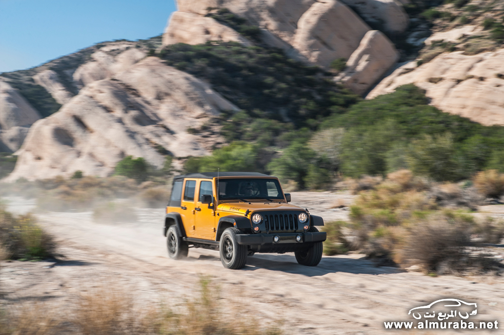 2014-jeep-wrangler-unlimited-willys-wheeler-edition-front-three-quarter-in-motion-03