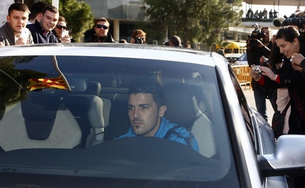 Barcelona's player Villa drives his car after the training session at Nou Camp stadium in Barcelona